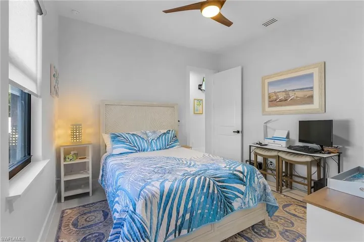 Bedroom with ceiling fan, visible vents, and baseboards