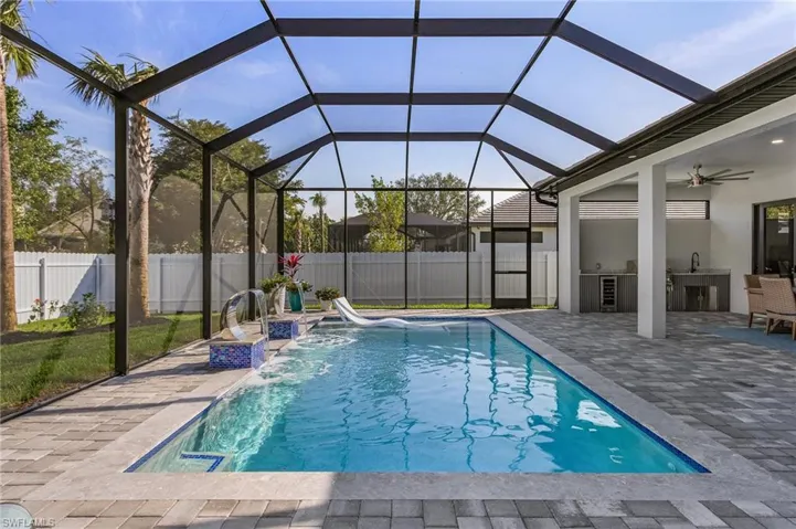 View of swimming pool with a patio, a fenced backyard, area for grilling, a ceiling fan, and a fenced in pool