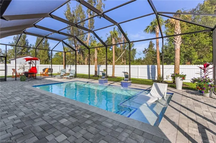 View of pool featuring a fenced in pool, a patio area, a fenced backyard, and a lanai