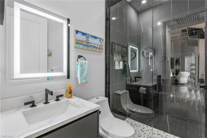 Full bath with a stall shower, vanity, and toilet
