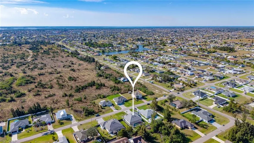 Drone / aerial view featuring a water view and a residential view