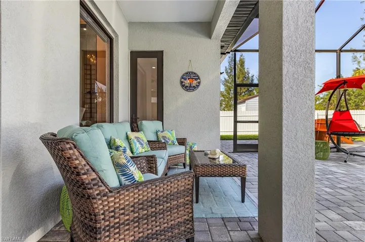 View of patio / terrace with a lanai, fence, and an outdoor hangout area
