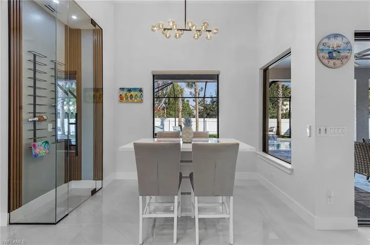 Dining area featuring a notable chandelier, baseboards, and a wealth of natural light