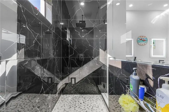 Full bathroom featuring a marble finish shower
