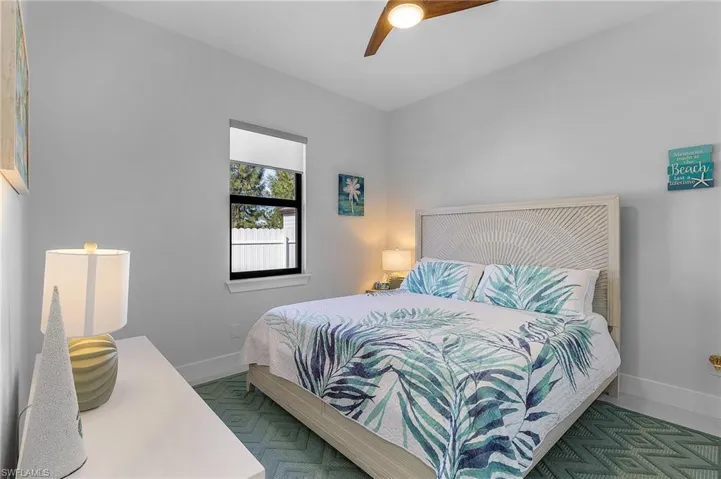 Bedroom with ceiling fan and baseboards