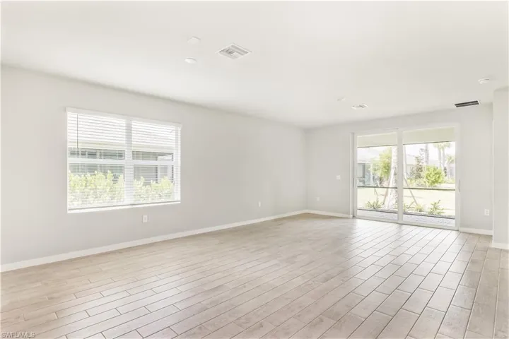 Empty room with plenty of natural light and light wood-style flooring