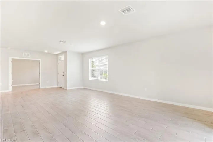 Unfurnished room with light wood-style floors and recessed lighting