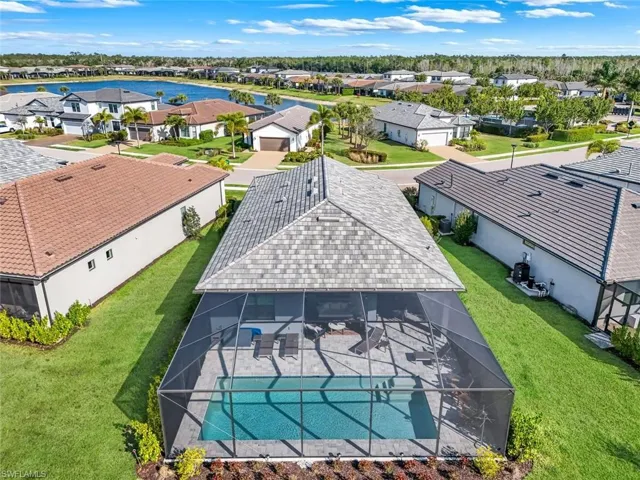 Aerial view of home featuring a screened cage with pool