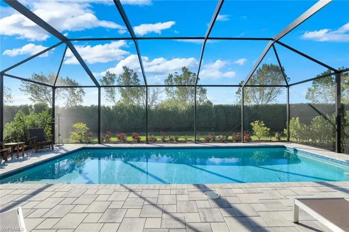 Swimming pool with patio and screened enclosure