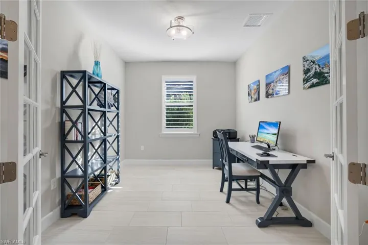 Office space featuring baseboards and french doors