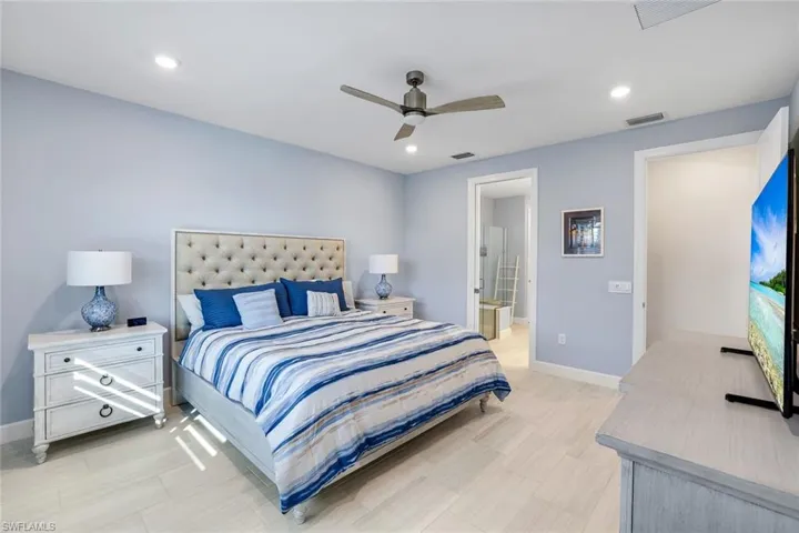 Master Bedroom featuring connected bathroom, a ceiling fan, and recessed lighting