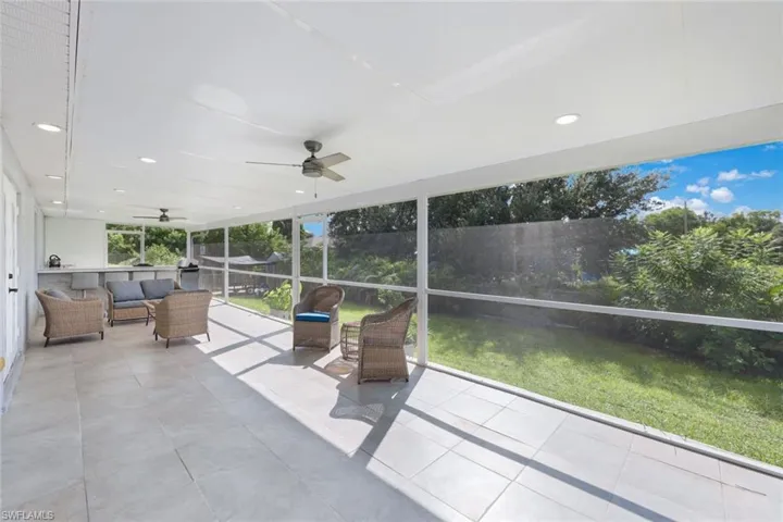 Unfurnished sunroom featuring ceiling fan