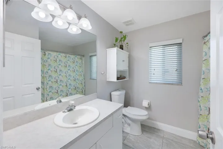 Bathroom featuring tile patterned floors, toilet, and vanity