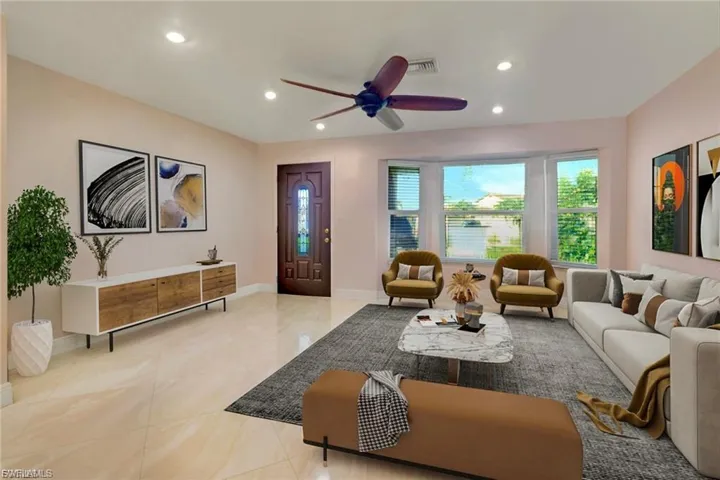 Living room featuring a ceiling fan and recessed lighting