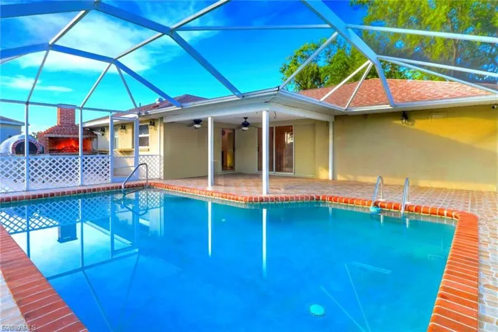 Swimming pool featuring a sunroom, a patio, and a lanai