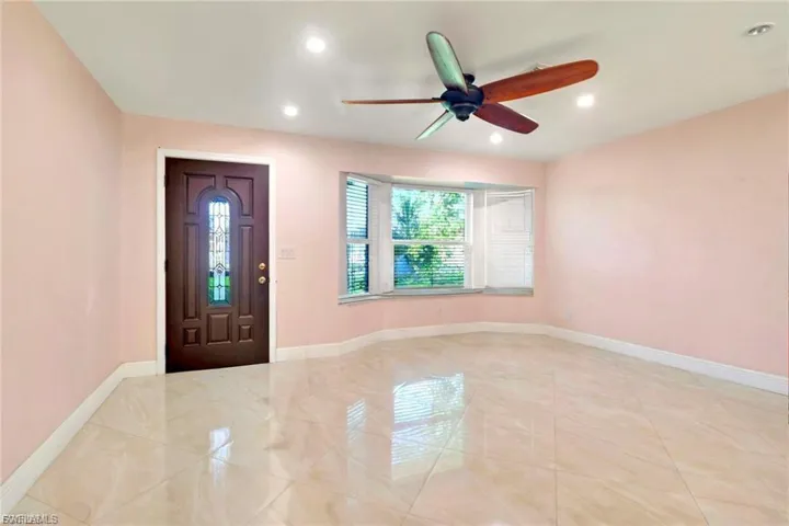 Foyer entrance with a ceiling fan and recessed lighting