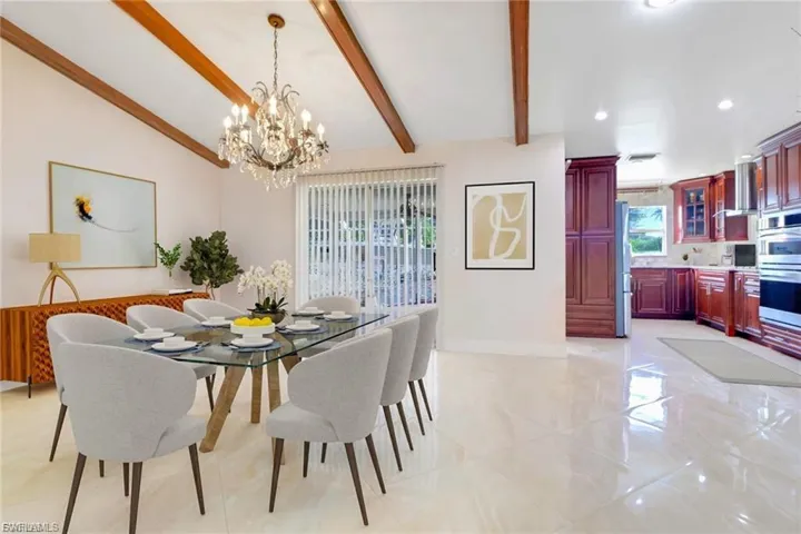 Dining room featuring baseboards and a chandelier