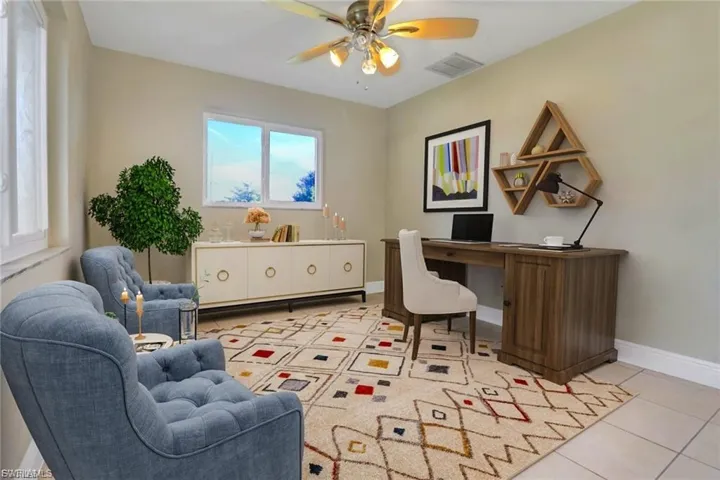 Home office with light tile patterned flooring and ceiling fan