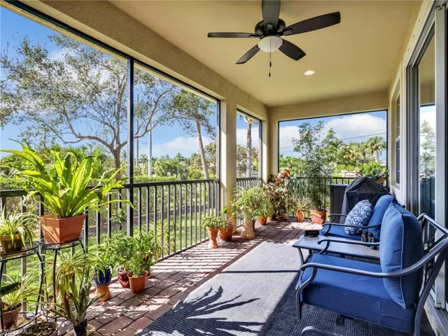 Screened-In Lanai with Paver Flooring, Screened Door to the Backyard, and Landscaped View
