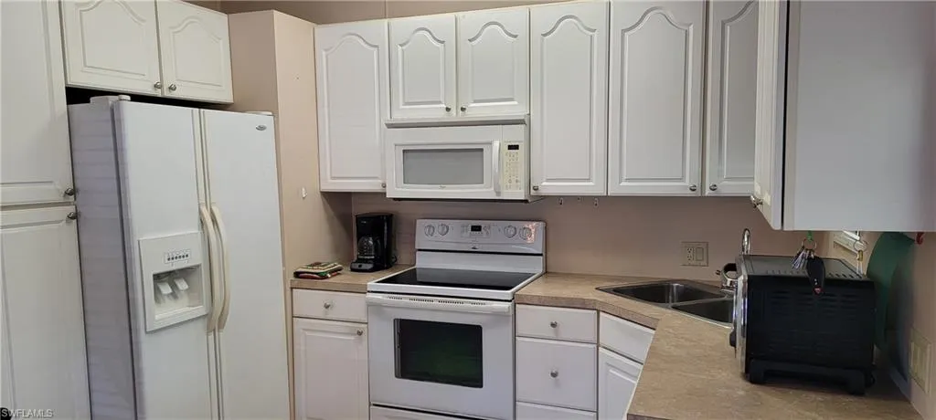 Kitchen, white appliances and white cabinetry