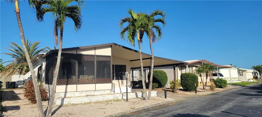 View of front of home with a sunroom