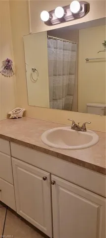 Bathroom with tile flooring, vanity,