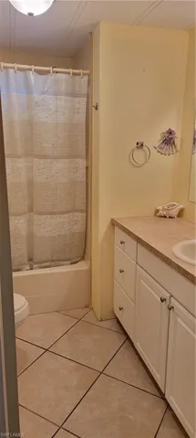 Full bathroom featuring tile floors, shower / bath combination