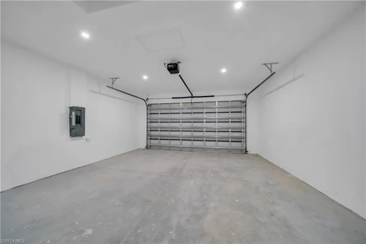 Garage with electric panel and a garage door opener