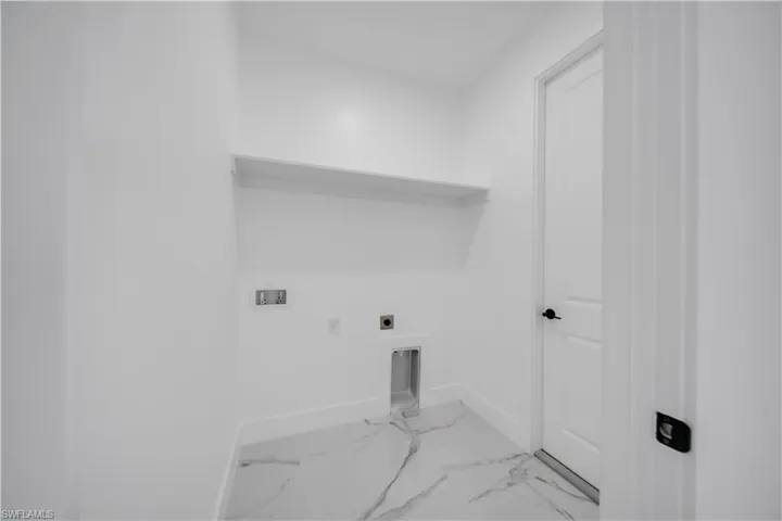 Laundry area featuring hookup for an electric dryer, washer hookup, and marble finish flooring