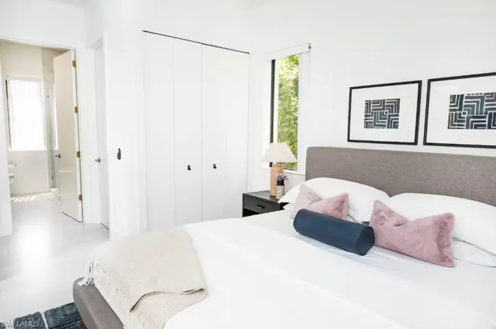 Master bedroom with a closet, and a master bathroom view