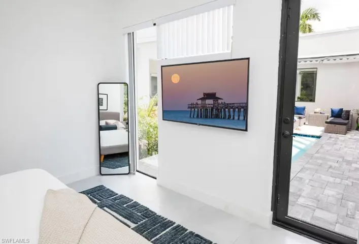 Master bedroom with a swimming pool view