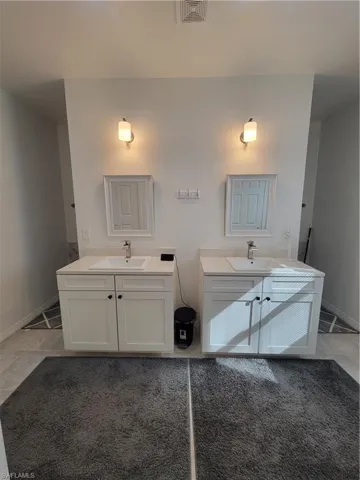 Bathroom featuring tile patterned floors, toilet, and sink