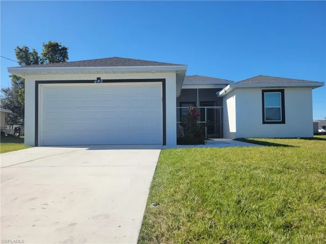 Ranch-style home with a front yard and a garage