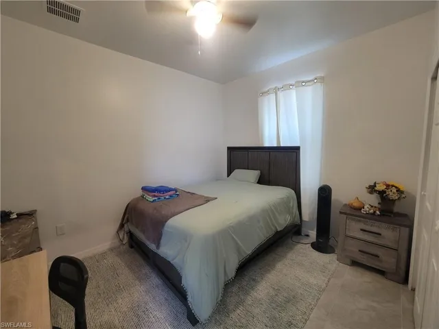Full bathroom featuring shower / tub combination, tile patterned flooring, vanity, and toilet