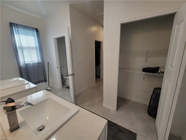 Bathroom with tile patterned flooring and vanity