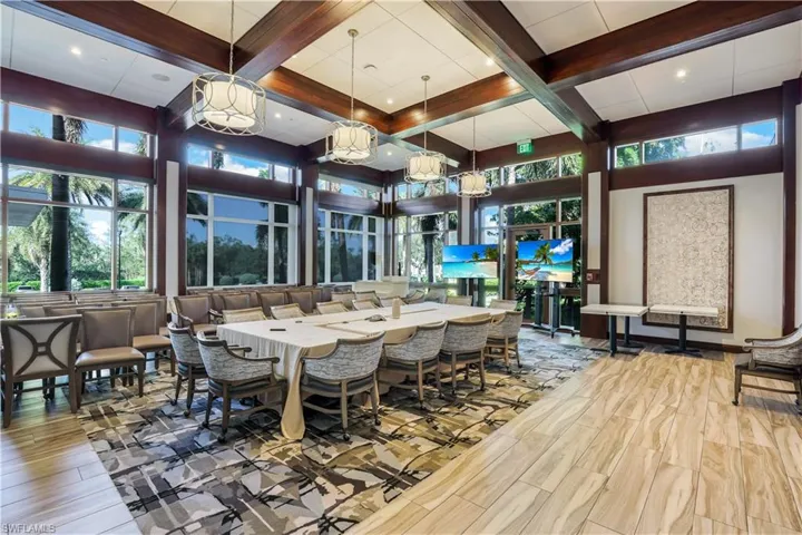 Dining room featuring coffered ceiling, wood finished floors, and plenty of natural light