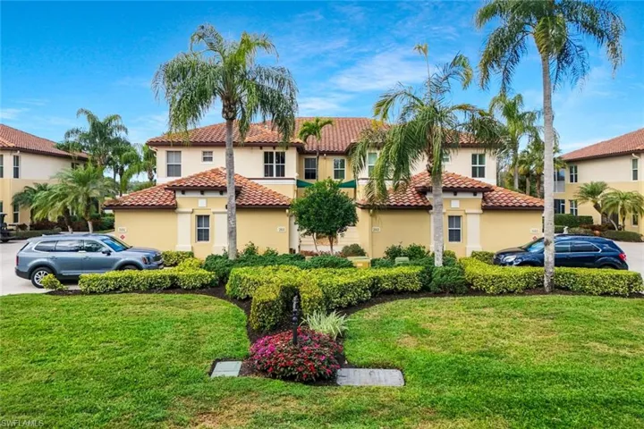 Mediterranean / spanish-style home with stucco siding, a tile roof, and a front yard