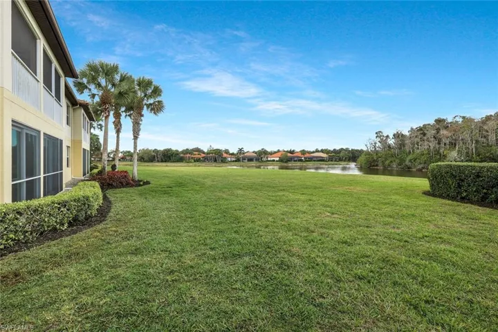 View of grassy yard with a water view