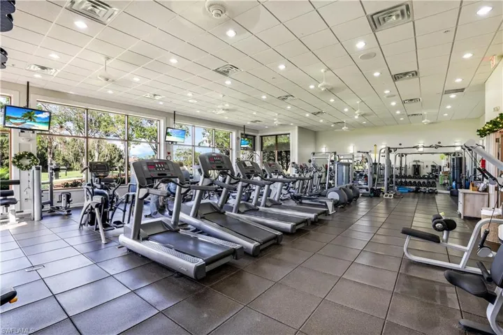 Workout area with recessed lighting and a drop ceiling