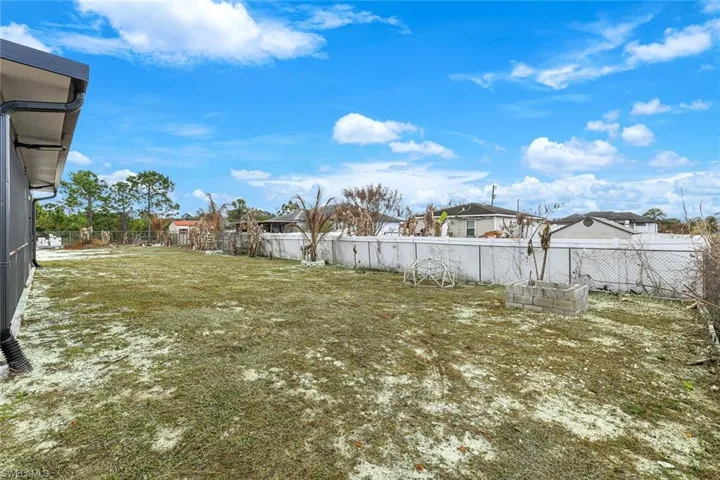 Fenced backyard with a residential view