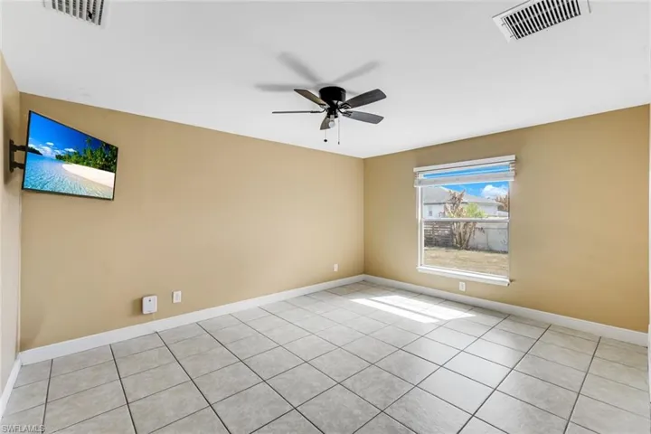 Unfurnished room featuring a ceiling fan and light tile patterned flooring