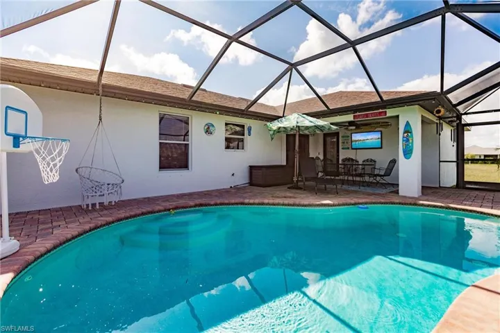 View of pool featuring a patio area and a lanai