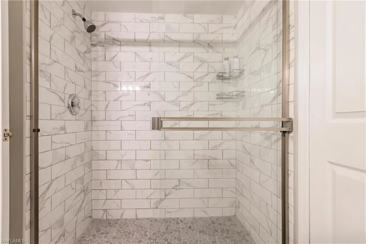 Bathroom featuring a shower with door