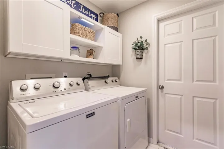 Washroom with cabinets and washing machine and dryer