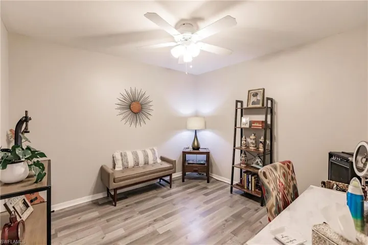 Office with hardwood / wood-style floors and ceiling fan