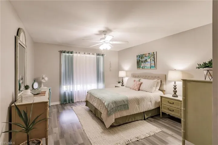 Bedroom featuring ceiling fan and hardwood / wood-style flooring
