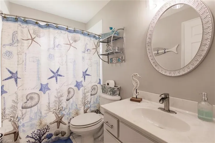 Bathroom with tile patterned flooring, toilet, and vanity