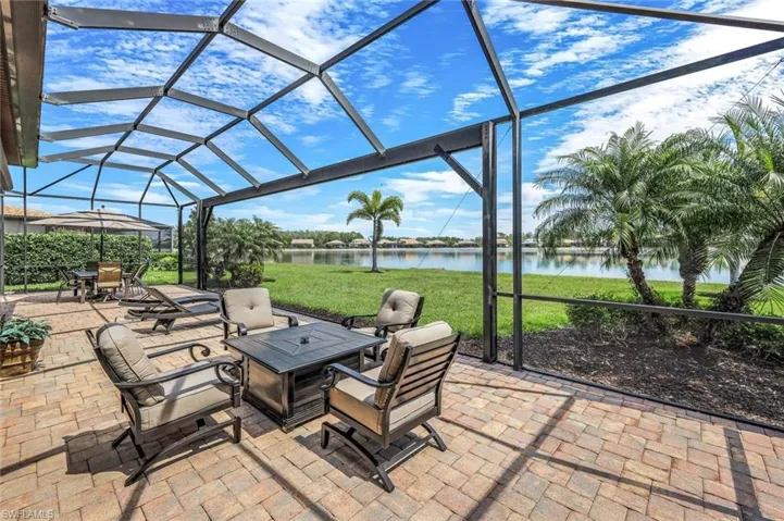 View of patio featuring a lanai, a sunroom, and a water view