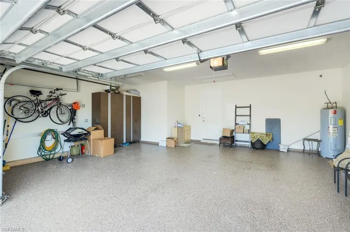 Garage with electric water heater and a garage door opener
