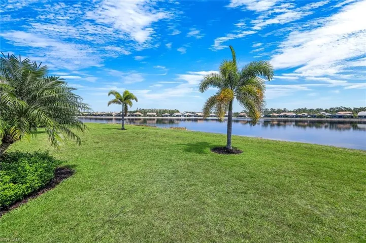 View of grassy yard with a water view